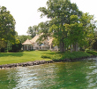 Another beautiful Lake mansion with green grass around it