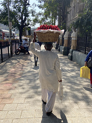 A random image of a person carried a basket of strowberries on his head