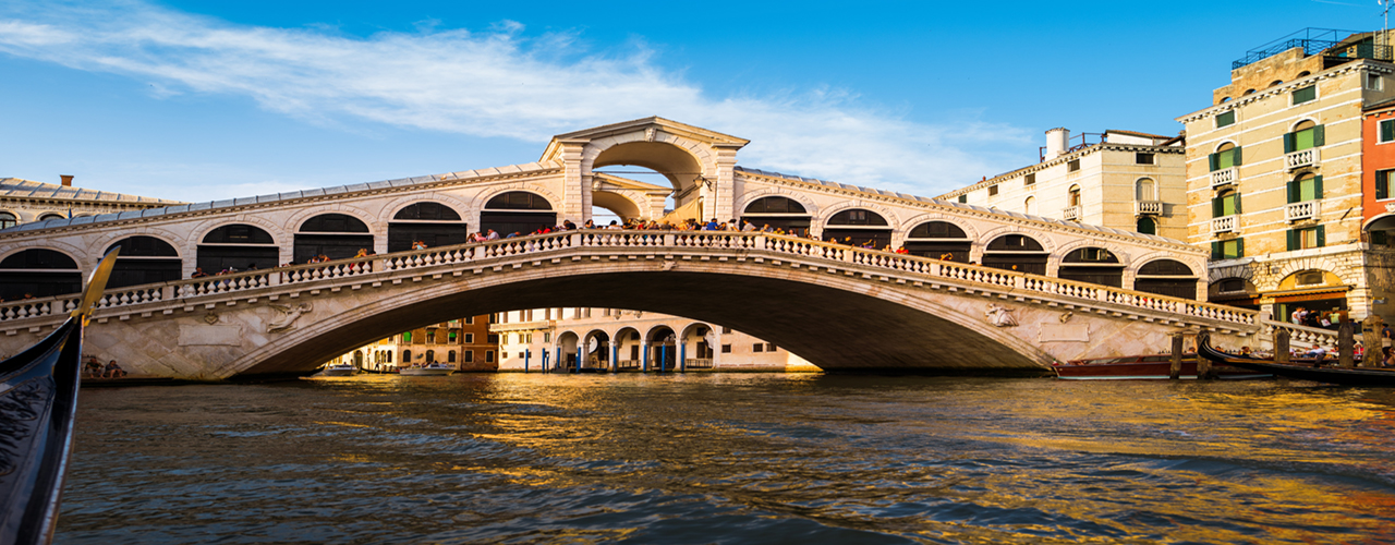 The image of Ponte di Rialto bridge - the oldest bridge in across Venice canal.