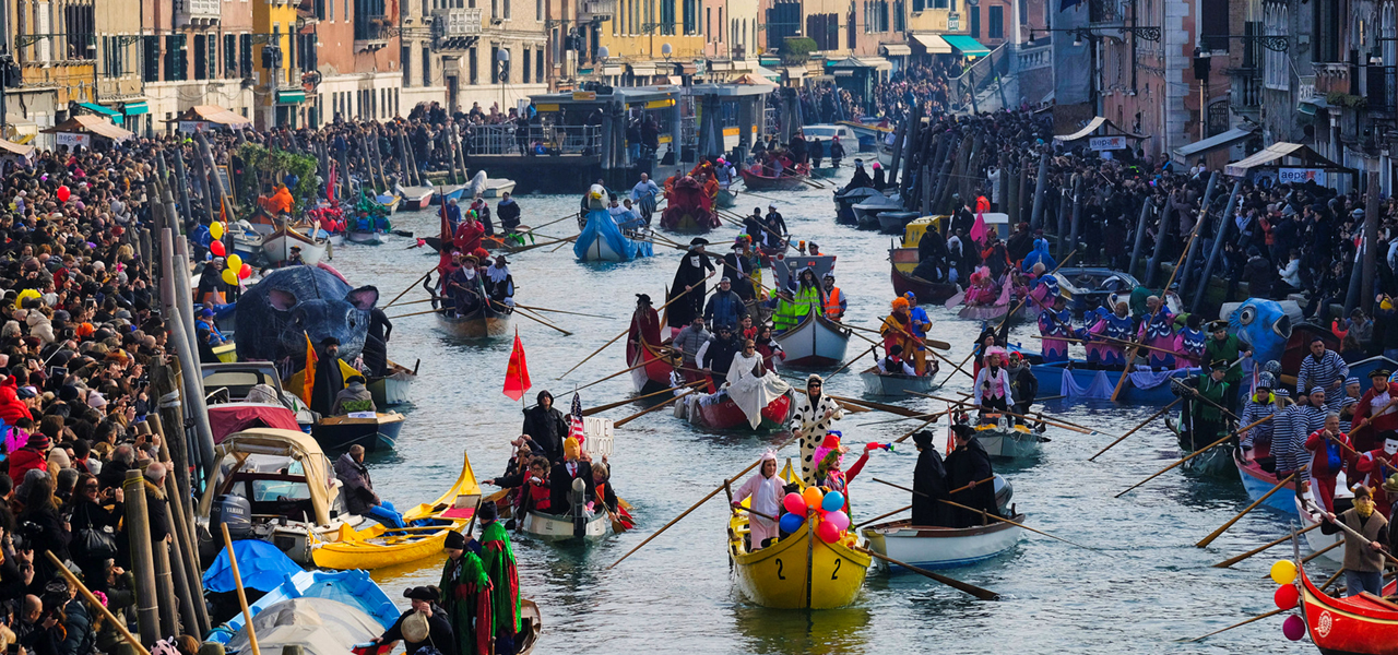 The image from Venice Carneval with boats in the Canal