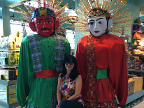 My wife with Ondel-ondel figures at Jakarta airport. 