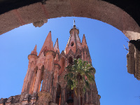 The Parish Church of San Miguel Arcangel with Gothic spires and a pink-colored façade.