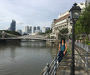 An image from Singapore river walk with bridges and modern buildings in the background. 