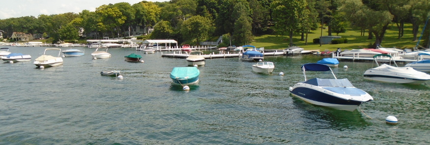 A beautiful Lake waterfront with a lot of anchored private boats