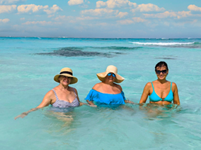 A beautiful photo of three ladies in turquoise water
