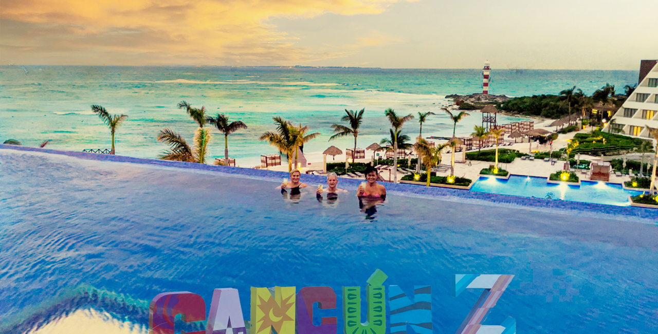 The infinity pool and 3 ladies enjoying coctails.