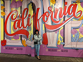 Image in front of California wall poster in pier 39